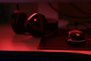 KYIV, UKRAINE - JULY 7, 2023 A4Tech Bloody G501 gaming headphones with microphone on table photo