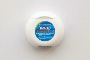 KYIV, UKRAINE - JULY 7, 2023 Oral-B Essentail Floss. Waxed dental floss in round case photo