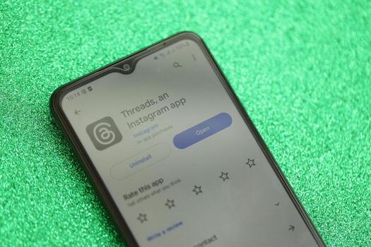 KYIV, UKRAINE - JULY 7, 2023 Threads by Meta application on display of Samsung smartphone lying on table photo