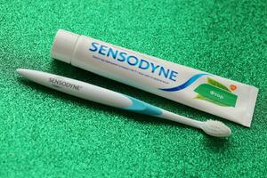 KYIV, UKRAINE - MAY 4, 2022 Sensodyne fluorine or fluor is a daily fluoride toothpaste photo