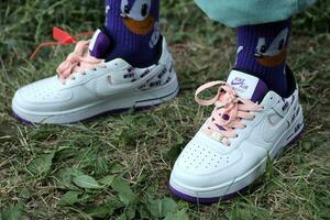 KYIV, UKRAINE - JULY 7, 2023 Fashion Sneakers Nike Air Force 1 on grass photo