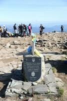 CARPATHIAN MOUNTAINS, UKRAINE - OCTOBER 8, 2022 Ukrainian monument at peak of Hoverla mountain in Carpathians photo