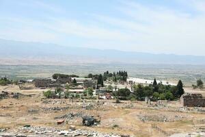 ANTALYA, TURKEY - MAY 15, 2021 Ruins of ancient city Hierapolis near Pamukkale, Turkey at sunny day. Parts of old historical buildings with big blocks photo