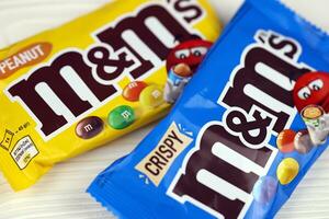 KHARKIV, UKRAINE - JANUARY 2, 2021 M and Ms colorful button shaped chocolate candies. Multi colored chocolates each of which has the letter m printed in lower case in white photo