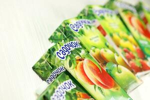 KHARKIV, UKRAINE - JANUARY 2, 2021 Sadochok various taste nectar from peach, apple and strawberry with orange flavour juice photo