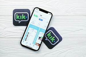 KHARKOV, UKRAINE - MARCH 5, 2021 Kik icon and application from App store on iPhone 12 pro display screen on white table photo