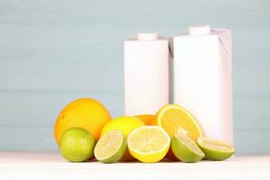 Juice pack with citrus extracts. Selective focus. Fresh juice package with lemon lime and orange photo