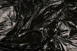 Texture of black plastic garbage disposable bag photo