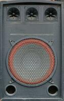 Old used audio speaker texture on dark blue photo