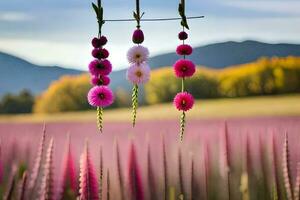 three pink flowers hanging from a wire in a field. AI-Generated photo