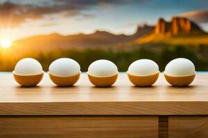 eggs in a row on a table with mountains in the background. AI-Generated photo