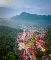 Serene Landscape Aerial View of Nature's Beauty with Mountains, Forests, and Greenery,Breathtaking aerial view of lush mountains, green forests, and a picturesque city skyline. photo