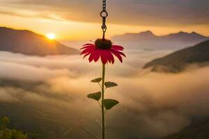 a red flower is hanging from a chain in front of a mountain. AI-Generated photo