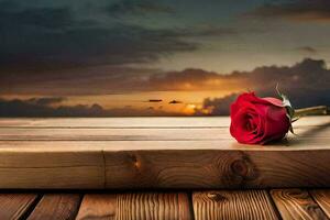 un soltero rojo Rosa se sienta en un de madera mesa en frente de un puesta de sol. generado por ai foto