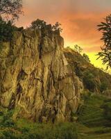 Tranquil Sunset over Wilderness Landscape Majestic landscape with mountain, cliffs, sunset, and tranquil atmosphere. photo