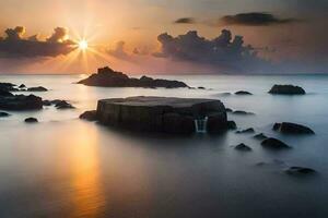 un hermosa puesta de sol terminado el Oceano con rocas y agua. generado por ai foto