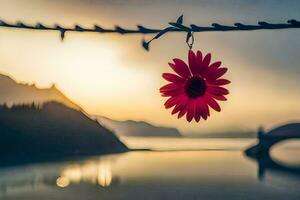a red flower hangs from a wire over a lake. AI-Generated photo