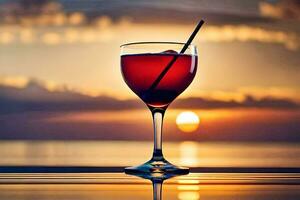 a glass of red wine with a straw on the beach at sunset. AI-Generated photo