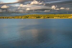 A sailboat on a cloudy evening photo