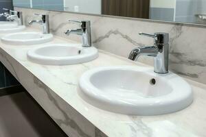 Modern public bathroom with row of white ceramic wash sink basins and faucet with mirror in restroom concept by AI Generated photo