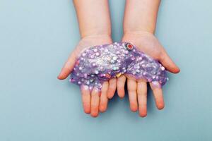 Making slime at home. child stretching colorful slime. DIY concept. photo