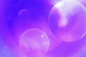 Oil bubbles close up. circles of water macro. abstract light blue background photo