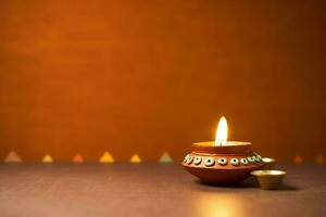 Happy diwali or deepavali traditional indian festival with clay diya oil lamp. Indian hindu festival of light symbol with candle and light. Clay diya lamp lit during diwali celebration by AI generated photo