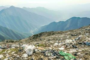 Environmental problem plastic garbage or trash in the mountain from global warming. Pollution concept by AI Generated photo