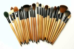 Set of professional makeup brushes cosmetic accessories set on white background. Makeup tool concept by AI Generated photo