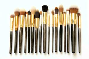 Set of professional makeup brushes cosmetic accessories set on white background. Makeup tool concept by AI Generated photo