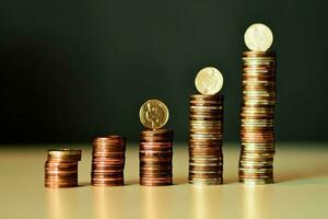 Stacks of savings coin arranged in ascending order on wooden working table or high coin towers representing the richness concept by AI Generated photo