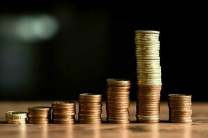 Stacks of savings coin arranged in ascending order on wooden working table or high coin towers representing the richness concept by AI Generated photo