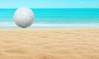 Beach landscape with soccer ball, summer season and water and blue sky background. photo