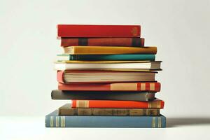 A book pile close up on a table. Front view pile book. For festival of world book day, national book day or national education day. Stack of colorful books on white background by AI Generated photo