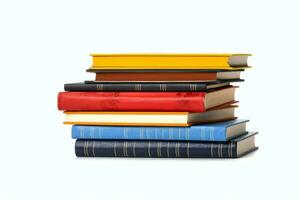 A book pile close up on a table. Front view pile book. For festival of world book day, national book day or national education day. Stack of colorful books on white background by AI Generated photo