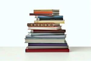 A book pile close up on a table. Front view pile book. For festival of world book day, national book day or national education day. Stack of colorful books on white background by AI Generated photo