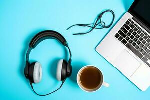 Music or podcast background with electronic devices, headphones, coffee and laptop on office desk concept by AI Generated photo