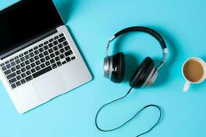 Music or podcast background with electronic devices, headphones, coffee and laptop on office desk concept by AI Generated photo