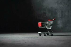 Composition of black friday shopping cart with gift boxes or bags on dark background and copy space concept by AI Generated photo