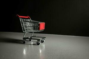 Composition of black friday shopping cart with gift boxes or bags on dark background and copy space concept by AI Generated photo