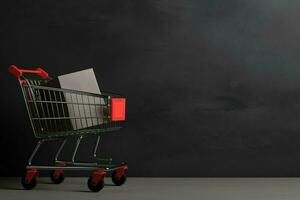 Composition of black friday shopping cart with gift boxes or bags on dark background and copy space concept by AI Generated photo