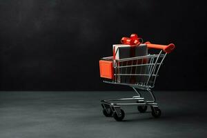 Composition of black friday shopping cart with gift boxes or bags on dark background and copy space concept by AI Generated photo