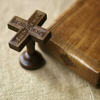 Close up of a holy bible and christian cross on wooden table. Happy good friday or religion concept by AI Generated photo