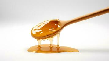 Honey dripping from a wooden spoon on a white background photo