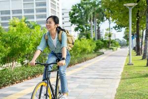 Asian woman riding a bicycle in the park. photo