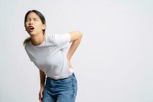 asiático mujer tiene espalda dolor, síntomas de oficina síndrome. foto