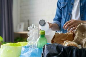 Close-up of woman sorting garbage. Garbage recycling concept. photo