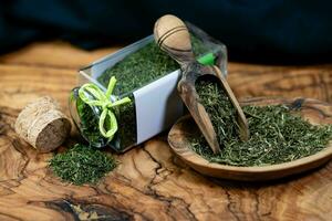 Dill Anethum graveolens on olive wood photo