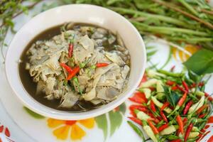 Local food, bamboo shoot curry, and  herbal vegetables on tray. Concept, Thai local food, Favorite in the north and north east of Thailand. Food from forest or garden. photo