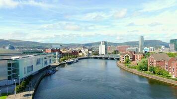 Aerial view on river and buildings in City centre of Belfast Northern Ireland. Drone photo, high angle view of town video